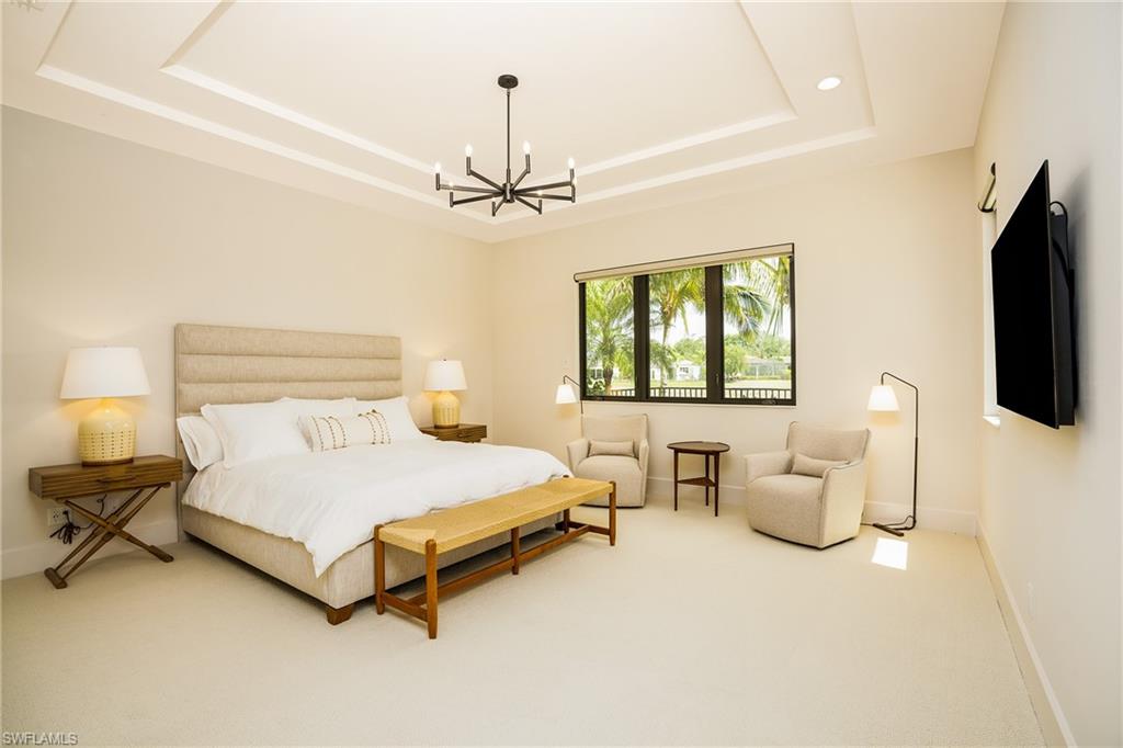 16708 Lucarno Way Naples, FL 34110 - Photo 33 of 46 a bedroom with bed and window