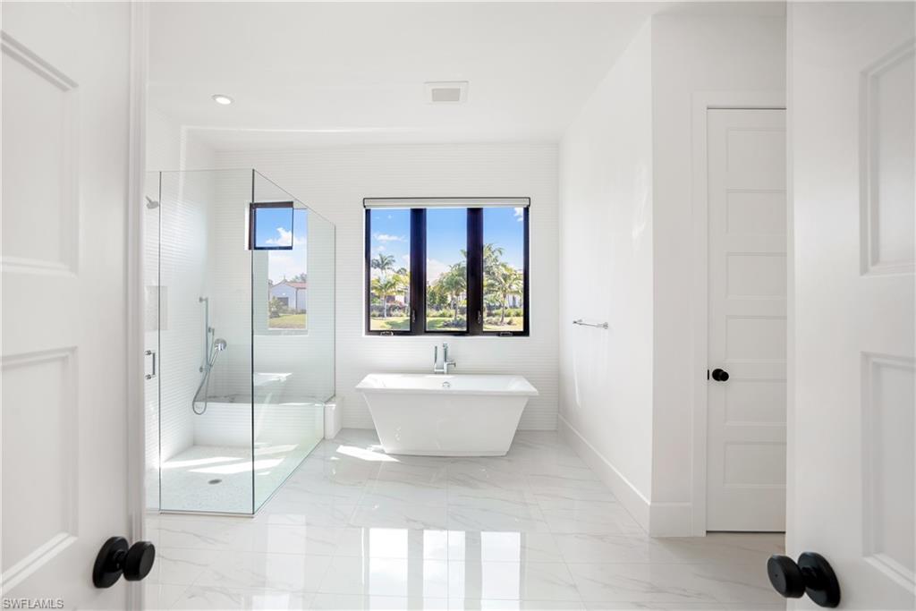 16708 Lucarno Way Naples, FL 34110 - Photo 35 of 46 a bathroom with a toilet a sink and bathtub