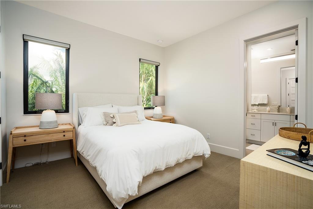 16708 Lucarno Way Naples, FL 34110 - Photo 38 of 46 a bedroom with a bed and large windows