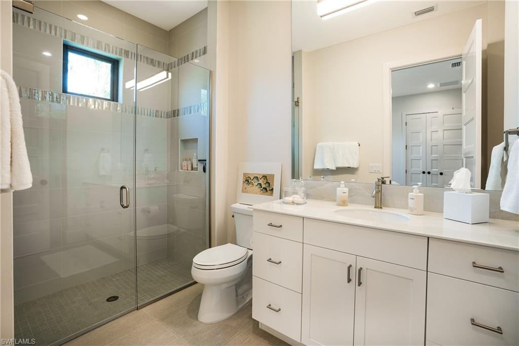 16708 Lucarno Way Naples, FL 34110 - Photo 39 of 46 a bathroom with a shower sink mirror and toilet