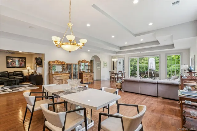 a view of a dining room with furniture a livingroom and chandelier