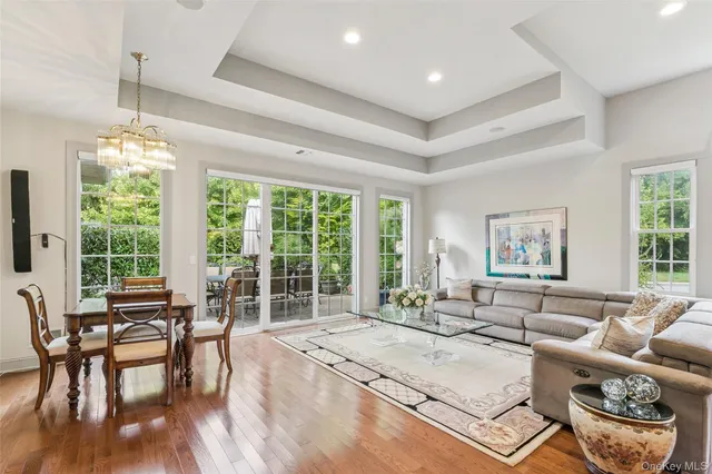 a living room with furniture and floor to ceiling windows