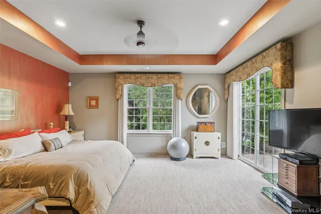 a bedroom with furniture and a large window