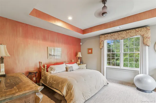 a bedroom with bed and a large window