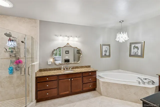 a spacious bathroom with a granite countertop tub sink and mirror