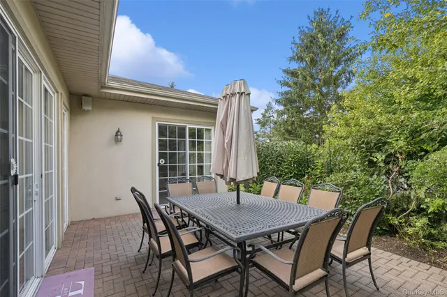 a view of patio with a table and chairs
