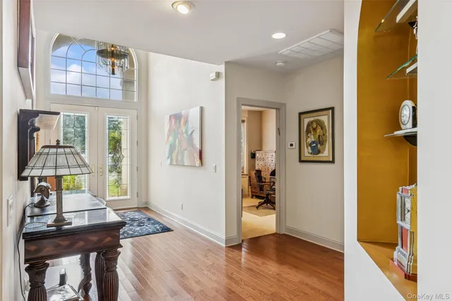 a view of a livingroom with wooden floor and furniture