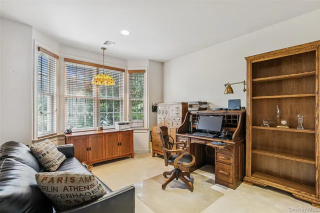 a livingroom with workspace and a window