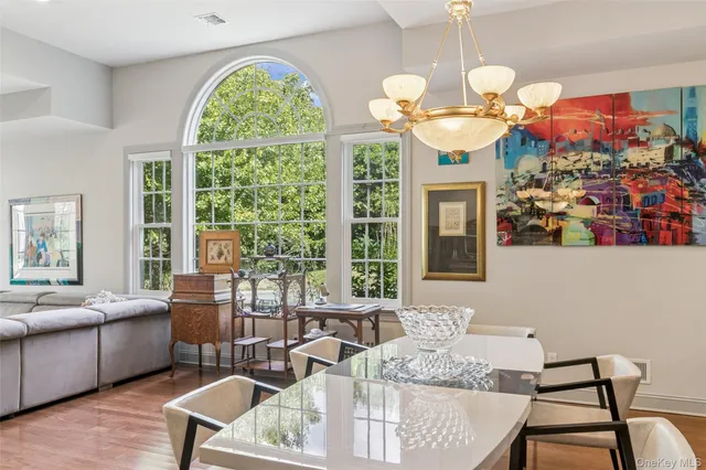 a living room with patio furniture and a large window