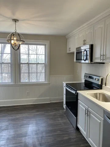 a kitchen with granite countertop a stove and a sink