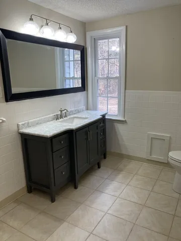 a bathroom with a sink vanity and mirror