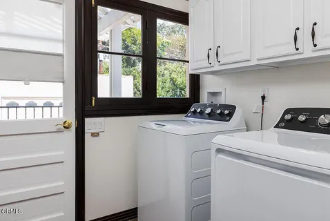 a kitchen with a stove a refrigerator and a window
