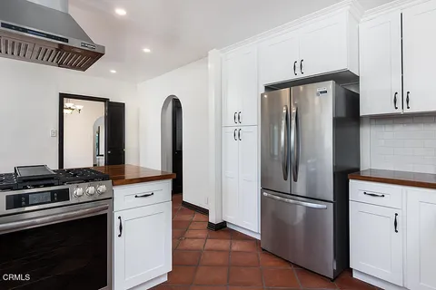 a kitchen with stainless steel appliances a refrigerator stove and sink
