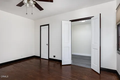 a view of an empty room with wooden floor