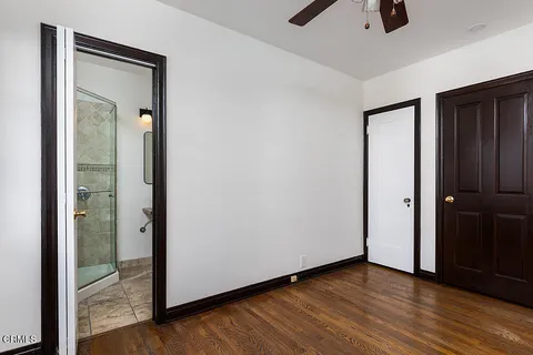 an empty room with wooden floor and closet