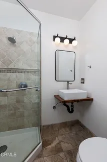 a bathroom with a sink toilet and shower