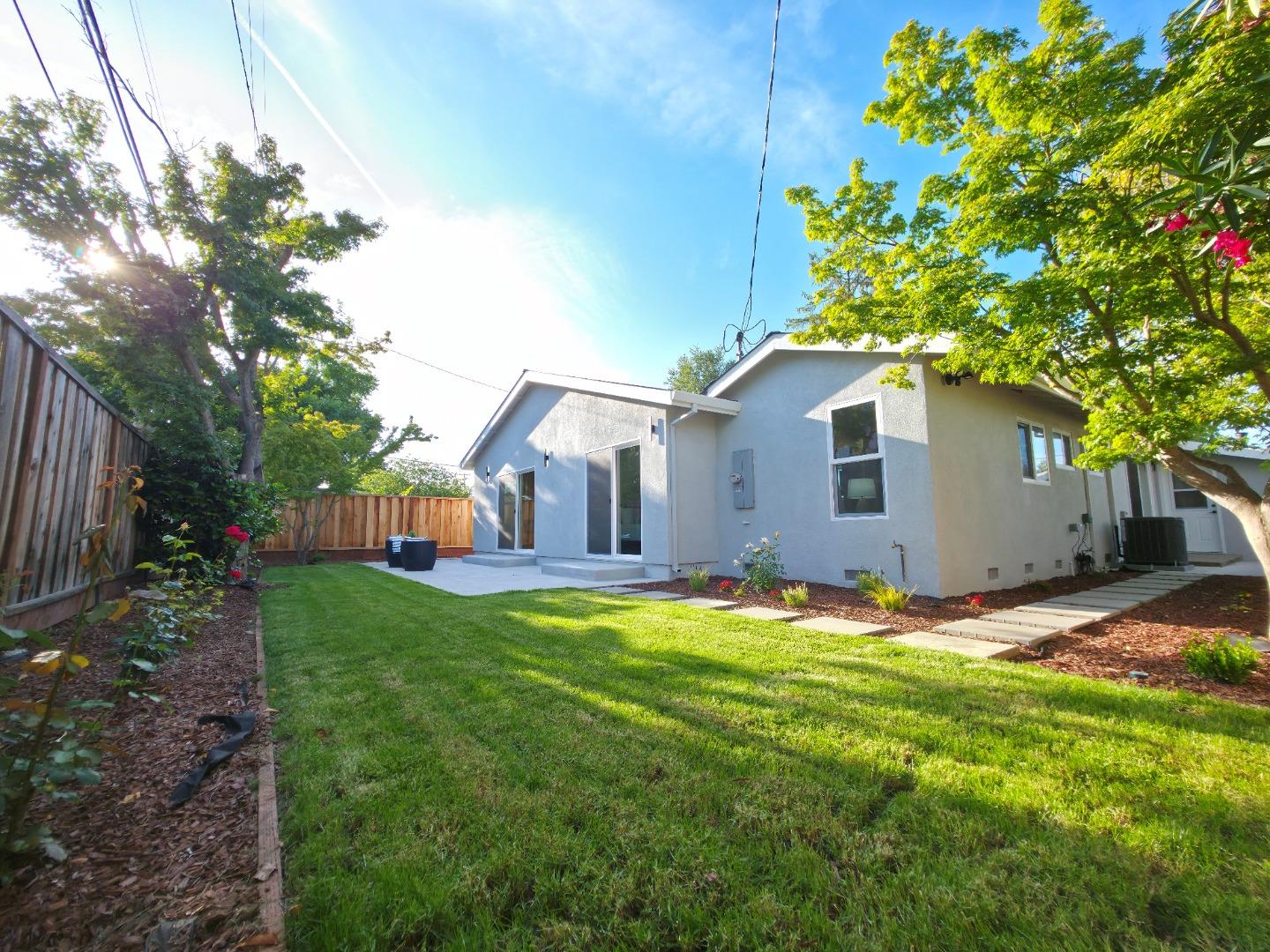 6746 Bollinger Road San Jose, CA 95129 - Photo 24 of 30 a backyard of a house with table and chairs plants and large tree