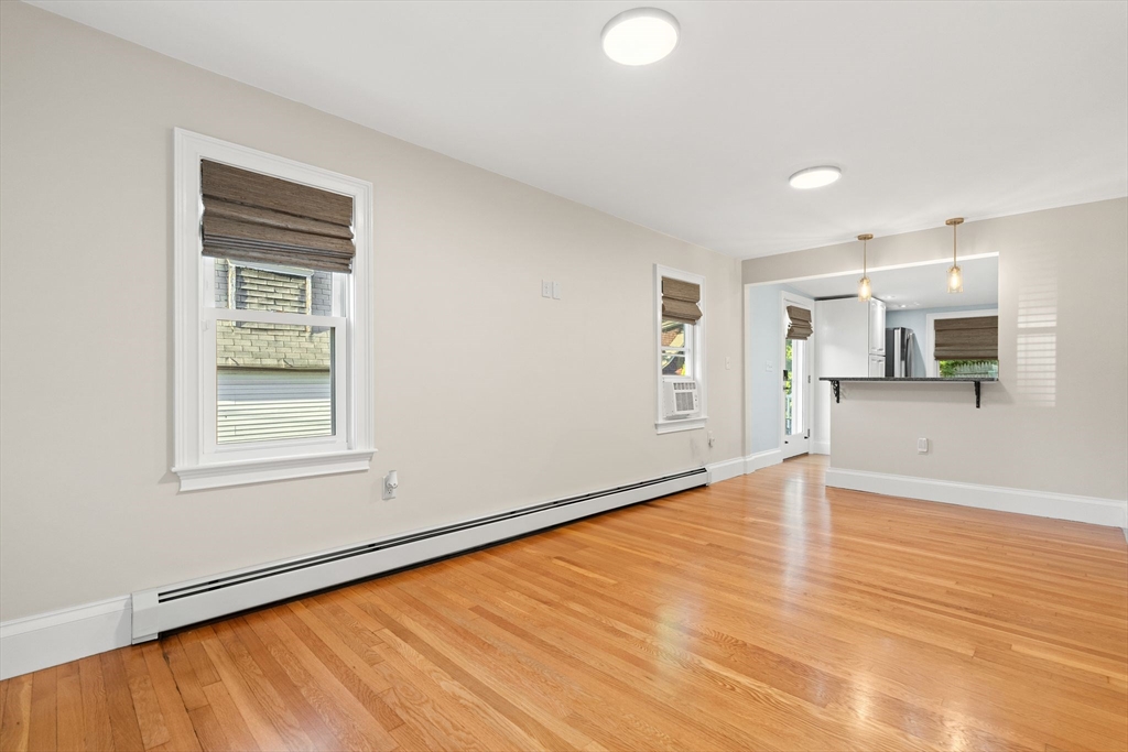 46 Gannett Road Quincy, MA 02169 - Photo 11 of 26 a view of an empty room with window and wooden floor