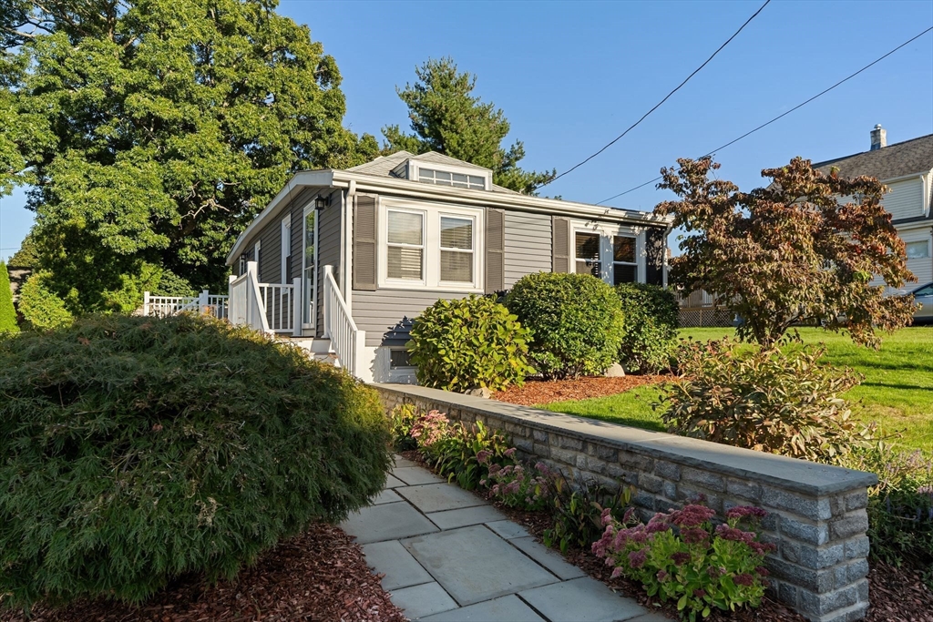 46 Gannett Road Quincy, MA 02169 - Photo 2 of 26 a front view of a house with a yard