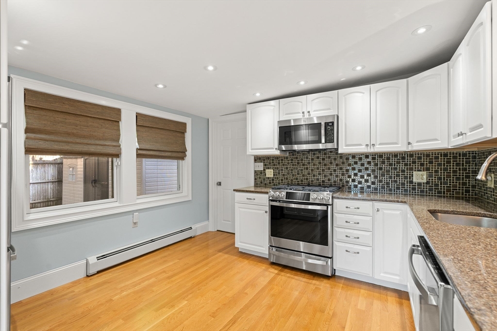 46 Gannett Road Quincy, MA 02169 - Photo 7 of 26 a kitchen with stainless steel appliances granite countertop a stove and a sink