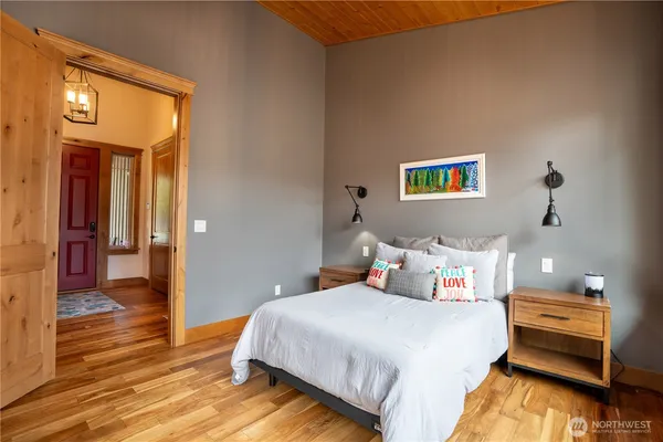 a bedroom with a bed and a painting on the wall