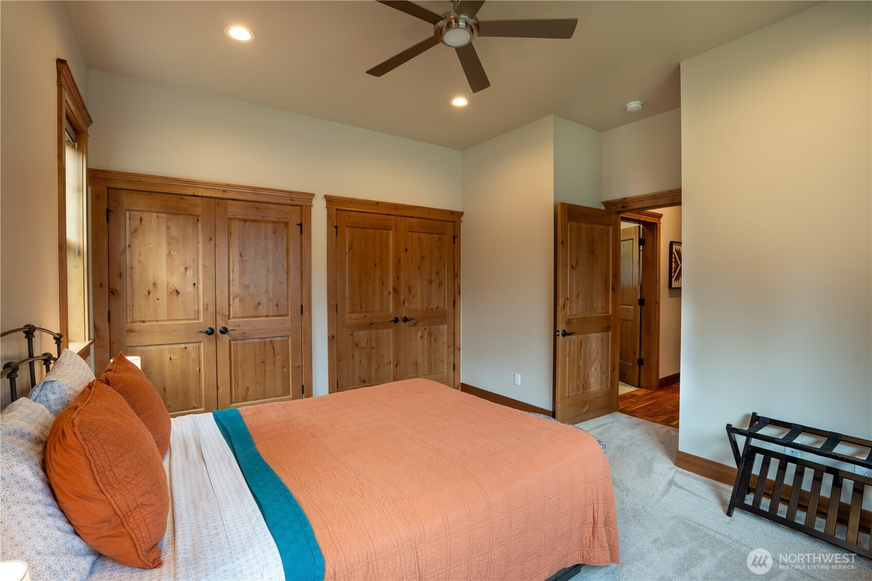 9047 Icicle Road Leavenworth, WA 98826 - Photo 16 of 30 a bedroom with a bed and a chandelier