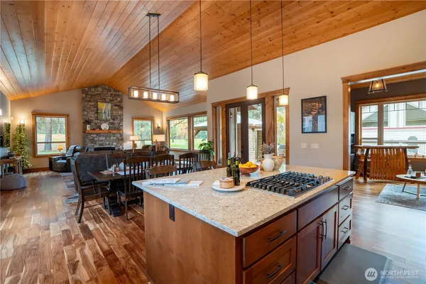 a kitchen with a table chairs and wooden floor