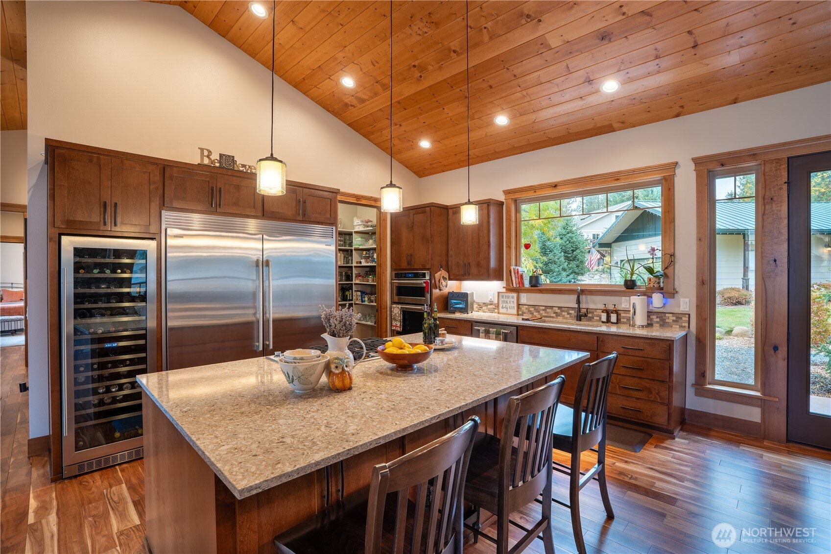 9047 Icicle Road Leavenworth, WA 98826 - Photo 4 of 30 a kitchen with a table chairs and refrigerator