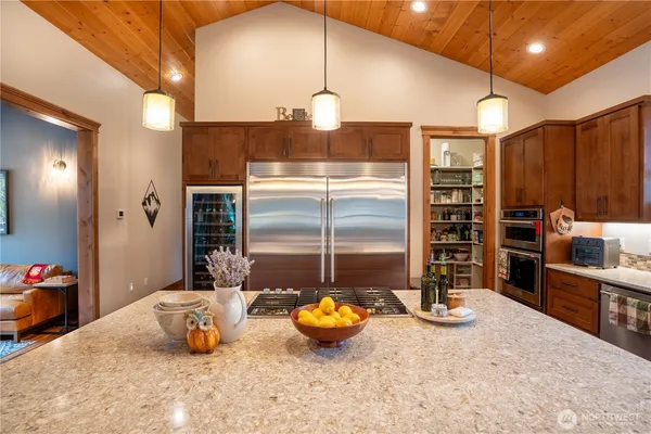 a kitchen with stainless steel appliances granite countertop a sink a counter and kitchen view