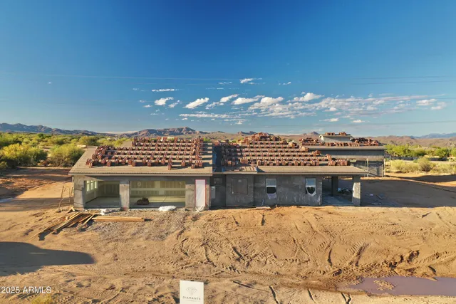 an aerial view of residential houses with outdoor space and trees
