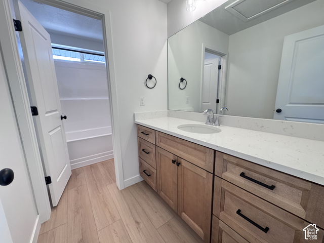 2613 Scarlet Road, Unit 258 Eagle Mountain, UT 84005 - Photo 18 of 30 Light wood-finish flooring with a white vanity featuring a light-colored countertop