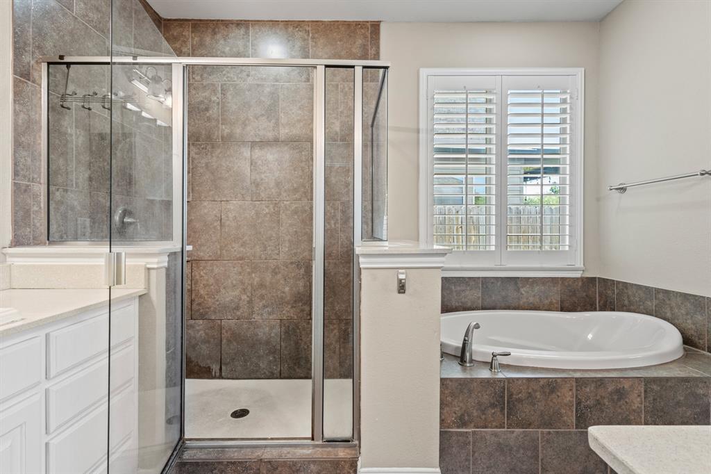 1036 Edgefield Lane Forney, TX 75126 - Photo 12 of 30 a bathroom with a granite countertop bathtub and shower