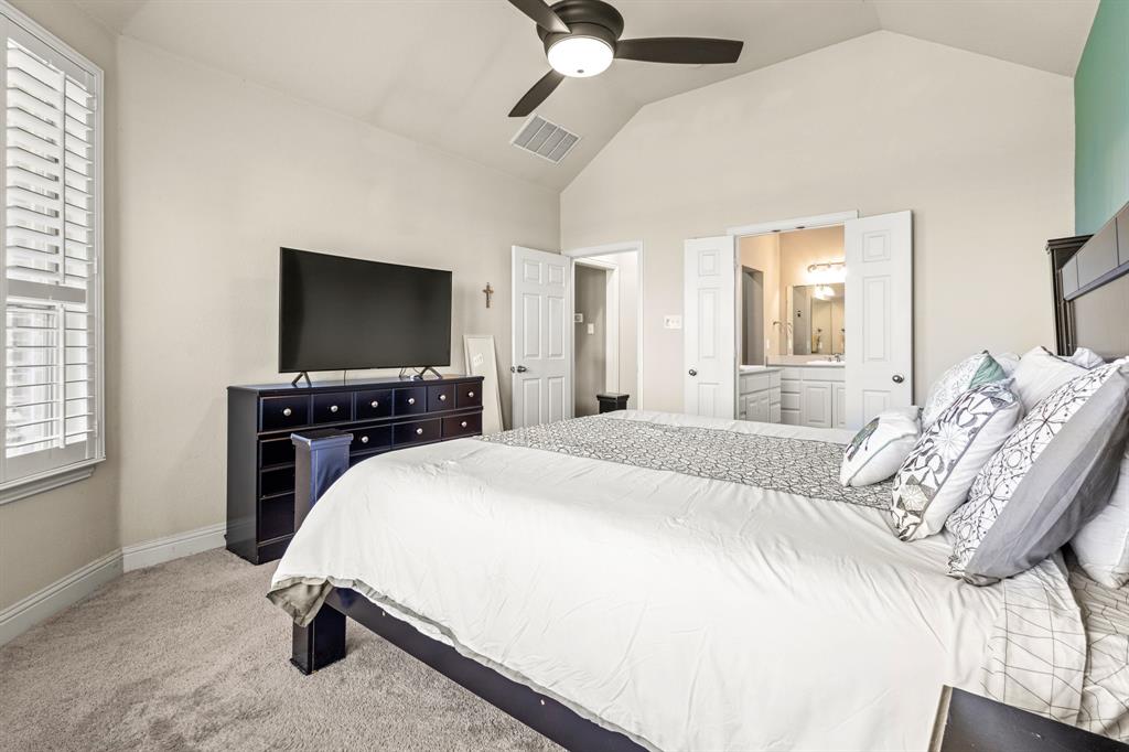 1036 Edgefield Lane Forney, TX 75126 - Photo 21 of 30 a bedroom with a bed and a flat screen tv