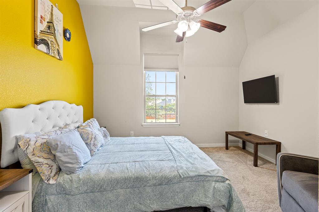 1036 Edgefield Lane Forney, TX 75126 - Photo 23 of 30 a bedroom with a bed and a flat screen tv