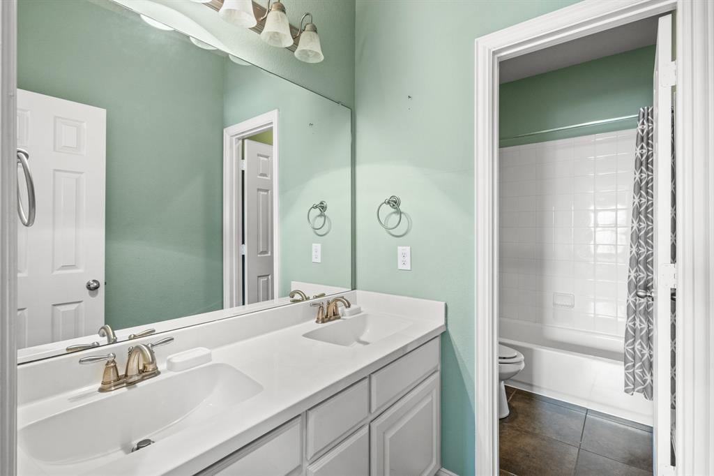 1036 Edgefield Lane Forney, TX 75126 - Photo 24 of 30 a bathroom with a sink and a mirror