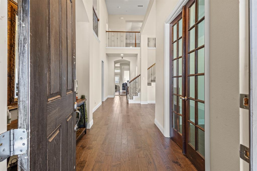 1036 Edgefield Lane Forney, TX 75126 - Photo 3 of 30 a view of a hallway with wooden floor and staircase