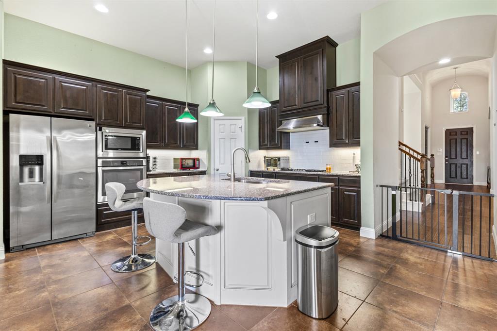 1036 Edgefield Lane Forney, TX 75126 - Photo 7 of 30 a kitchen with stainless steel appliances granite countertop a refrigerator a stove and a sink