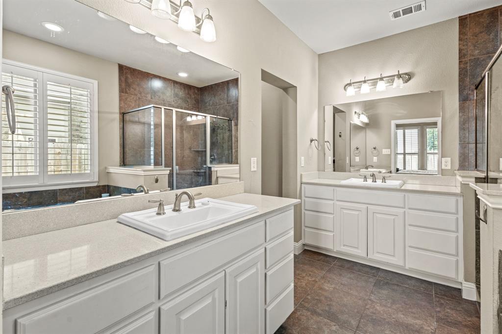 1036 Edgefield Lane Forney, TX 75126 - Photo 10 of 30 a spacious bathroom with a double vanity sink mirror and double