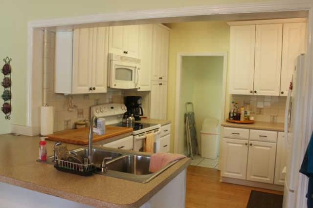 1490 Nails Creek Road Dickson, TN 37055 - Photo 6 of 11 a view of a kitchen with kitchen island a stove a sink and a window
