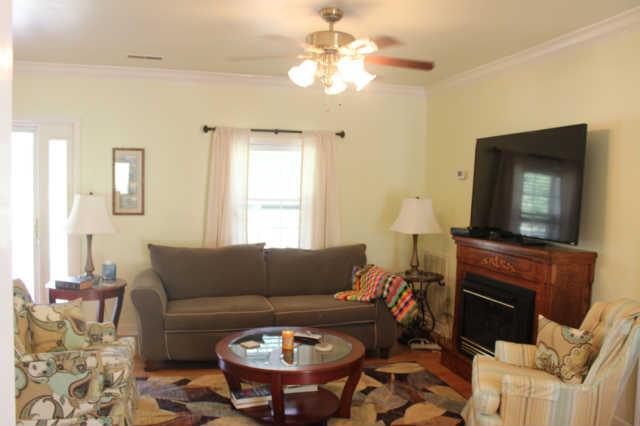 1490 Nails Creek Road Dickson, TN 37055 - Photo 8 of 11 a living room with furniture a fireplace and a flat screen tv