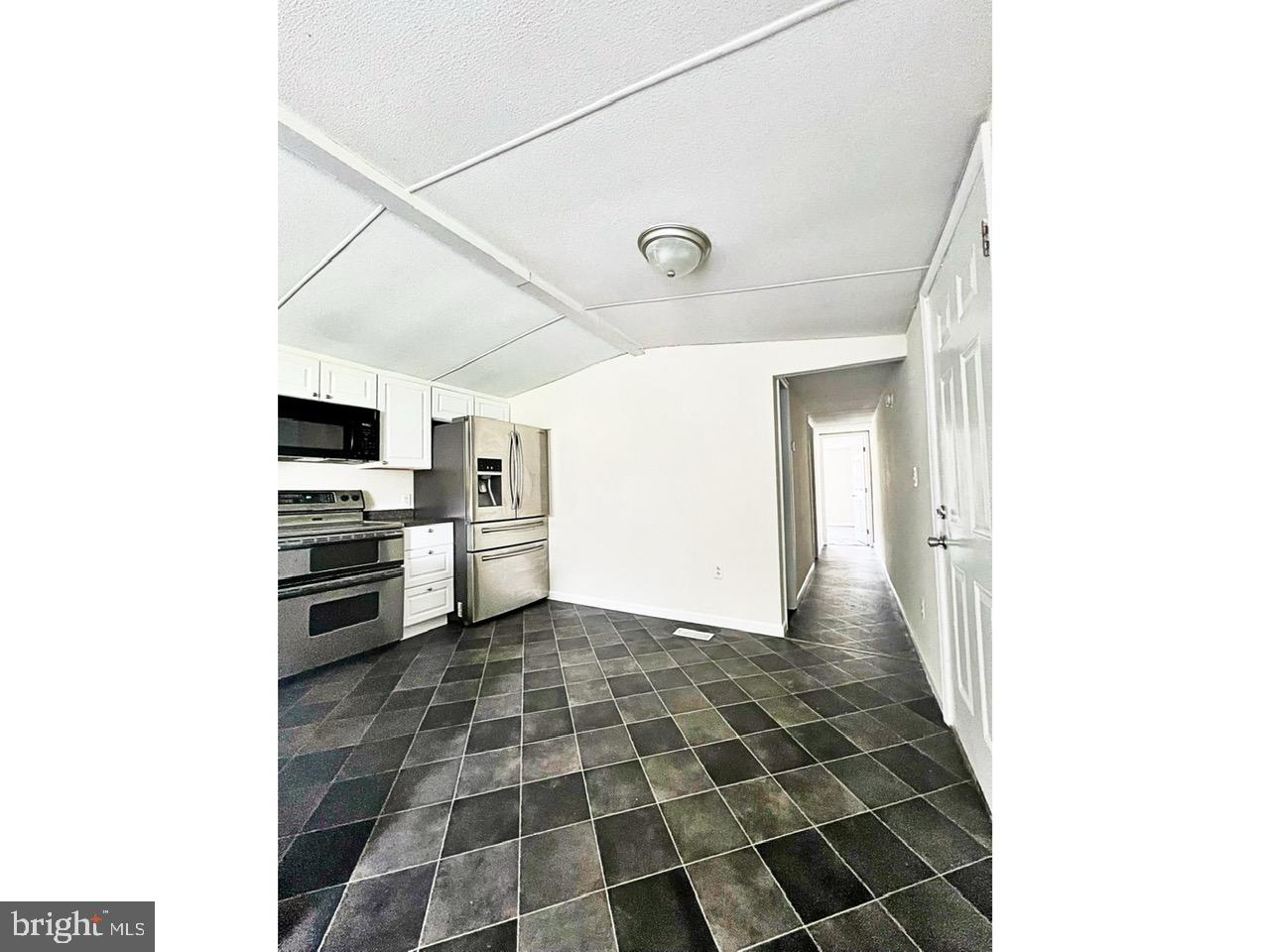2189 Downs Chapel Road Clayton, DE 19938 - Photo 4 of 13 a kitchen with a sink a stove top oven and cabinets