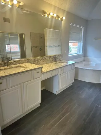 a bathroom with a granite countertop sink a large mirror and vanity