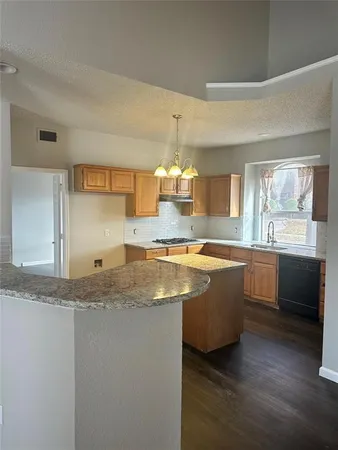 a view of a kitchen counter top space a sink and appliances
