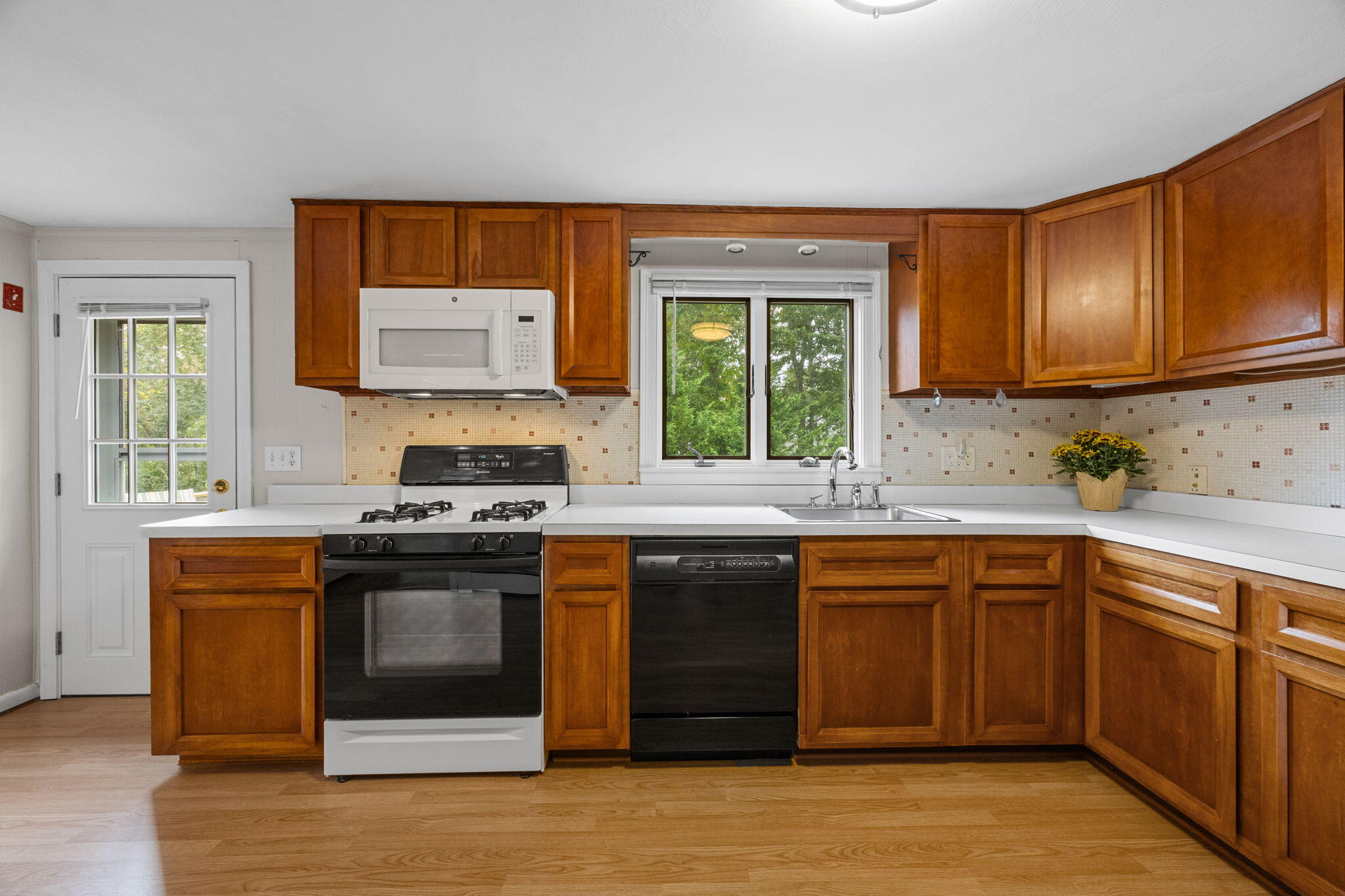 21 Green Way South Yarmouth, MA 02664 - Photo 14 of 42 a kitchen with stainless steel appliances granite countertop a stove a sink and a microwave