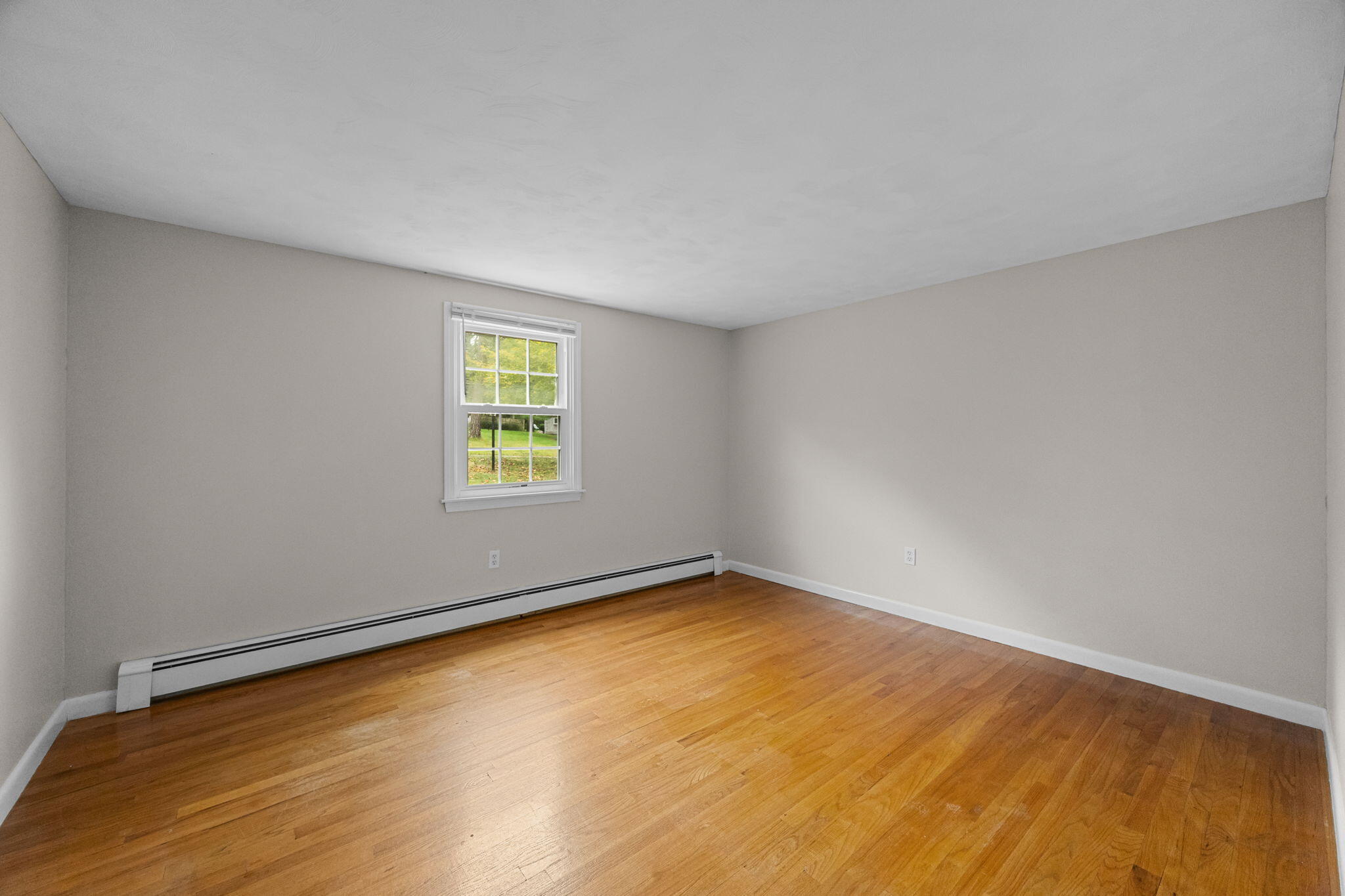 21 Green Way South Yarmouth, MA 02664 - Photo 19 of 42 a view of an empty room with wooden floor and a window