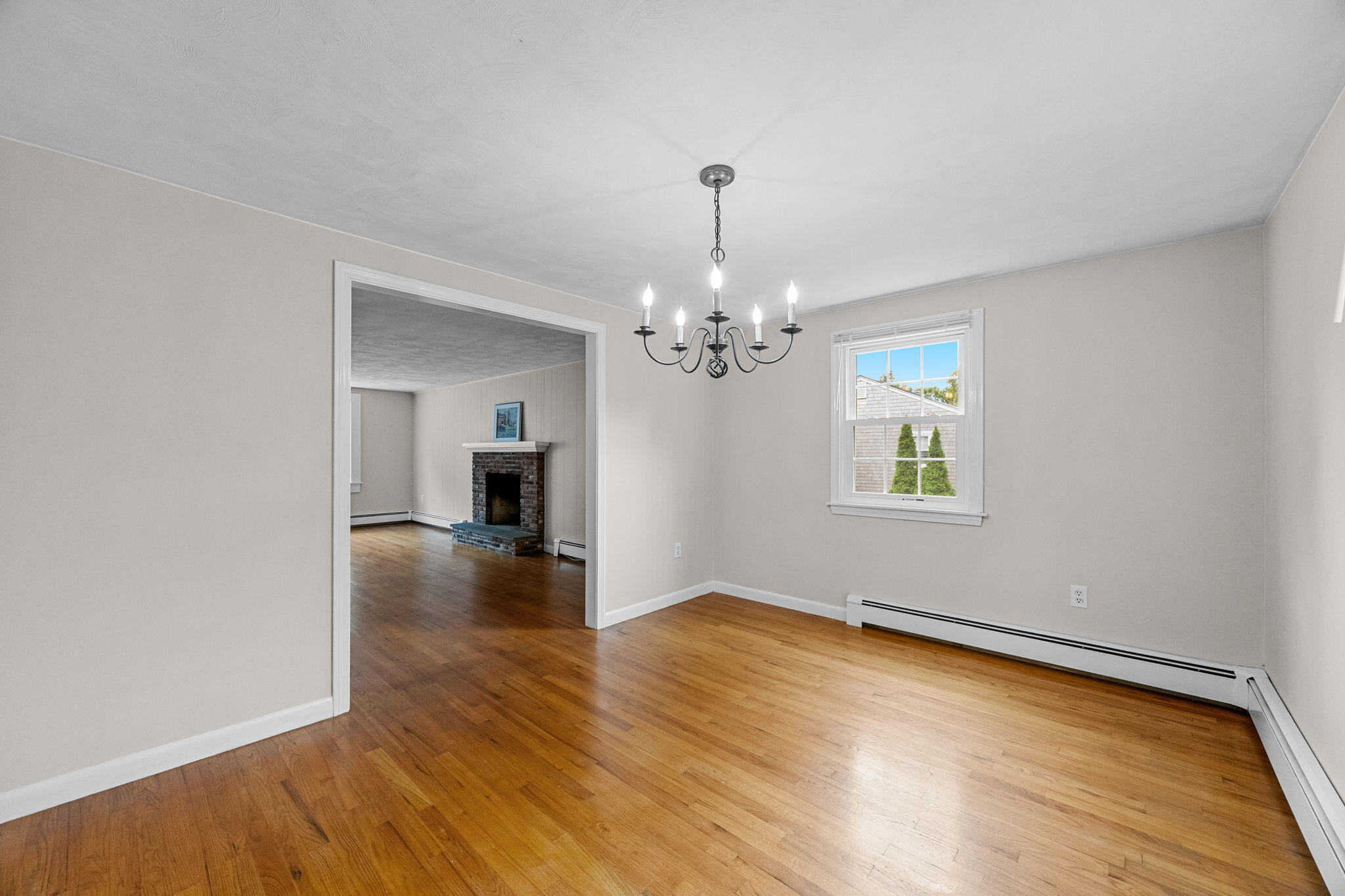 21 Green Way South Yarmouth, MA 02664 - Photo 9 of 42 a view of a livingroom with wooden floor and a chandelier