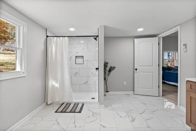 a bathroom with a shower and a sink