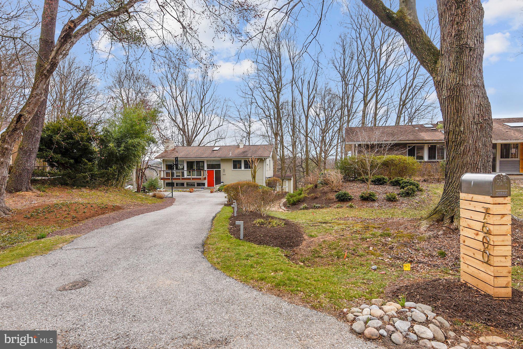 7600 Hamilton Spring Road Bethesda, MD 20817 - Photo 1 of 24 a front view of a house with a yard
