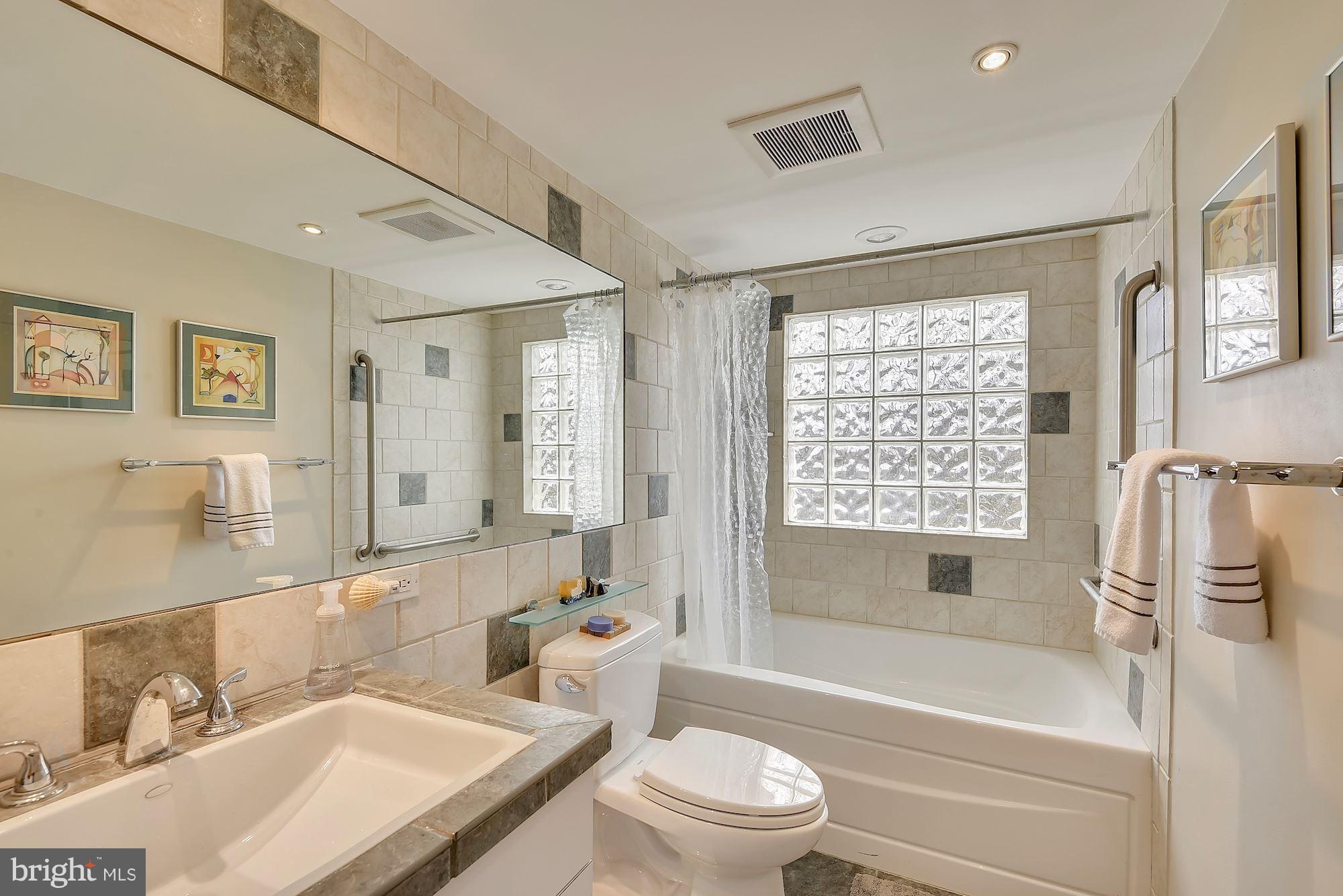 7600 Hamilton Spring Road Bethesda, MD 20817 - Photo 19 of 24 a bathroom with a granite countertop sink toilet tub and shower