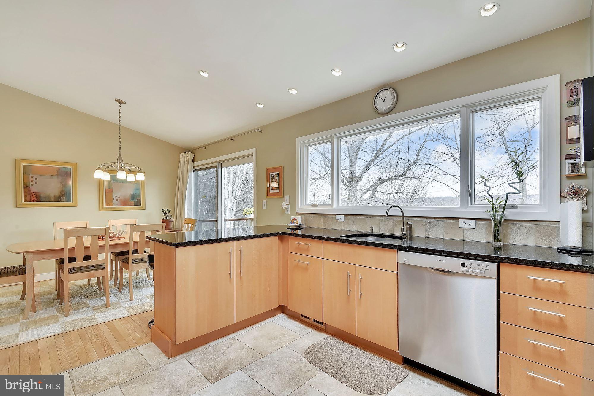 7600 Hamilton Spring Road Bethesda, MD 20817 - Photo 7 of 24 a large kitchen with granite countertop a large window and white cabinets